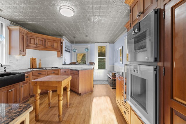 70 River Rd, East Haddam, CT 06423 - kitchen with an ornate ceiling, a peninsula, a sink, light wood-style floors, and decorative light fixtures