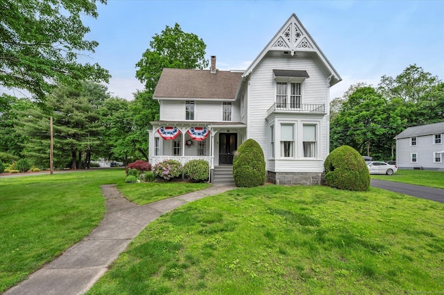 44 Maple Ave, Canton, CT 06019 - victorian-style house with a chimney, a front yard, and roof with shingles