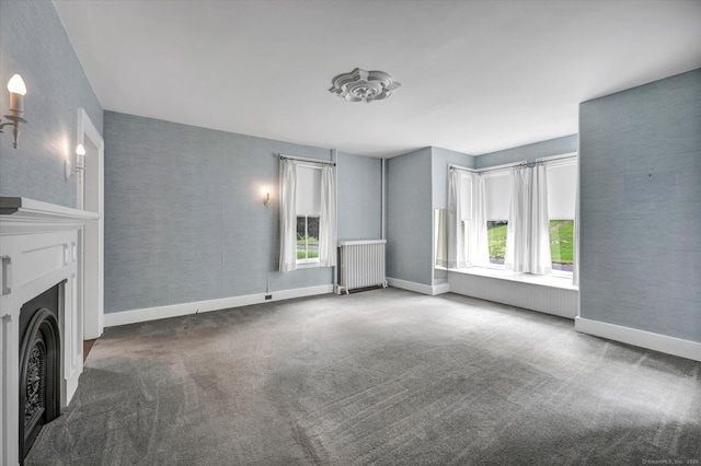 44 Maple Ave, Canton, CT 06019 - unfurnished living room featuring radiator, baseboards, a fireplace, and carpet floors