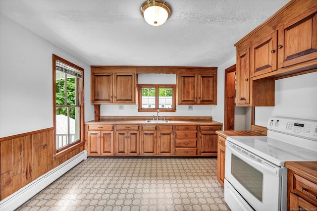 44 Maple Ave, Canton, CT 06019 - kitchen featuring electric range, a baseboard radiator, brown cabinetry, plenty of natural light, and wainscoting