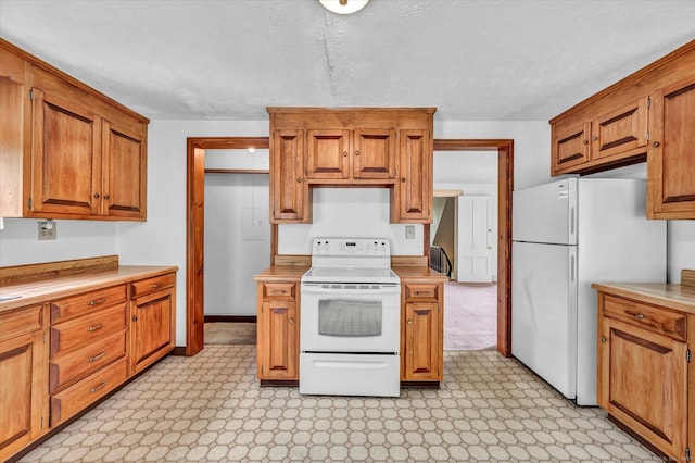 44 Maple Ave, Canton, CT 06019 - kitchen featuring white appliances, light countertops, brown cabinetry, light floors, and a textured ceiling