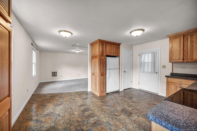 44 Maple Ave, Canton, CT 06019 - kitchen with freestanding refrigerator, baseboards, dark countertops, brown cabinets, and open floor plan