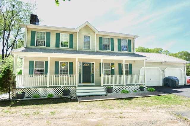 39 Warner St, Bristol, CT 06010 - view of front of property with covered porch, a chimney, asphalt driveway, and a garage
