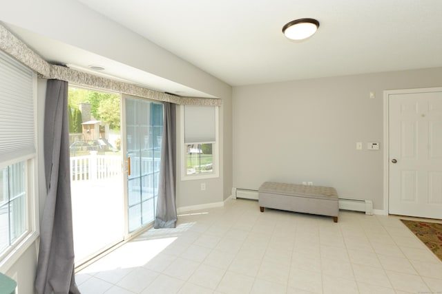 39 Warner St, Bristol, CT 06010 - living area with plenty of natural light, baseboards, and a baseboard heating unit