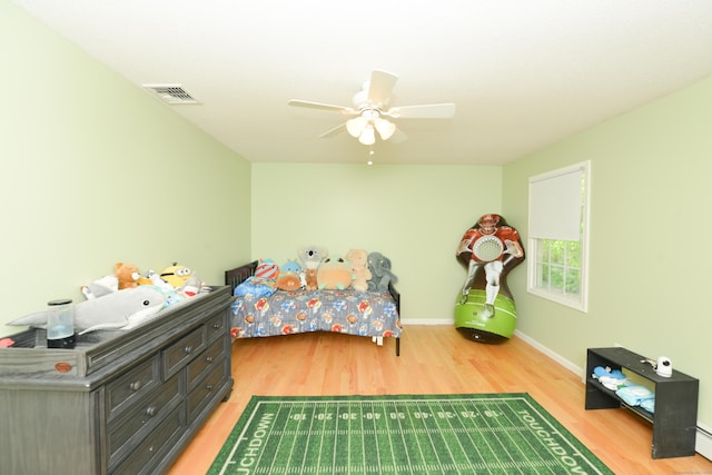 39 Warner St, Bristol, CT 06010 - bedroom featuring light wood-type flooring, baseboards, a ceiling fan, and a baseboard heating unit