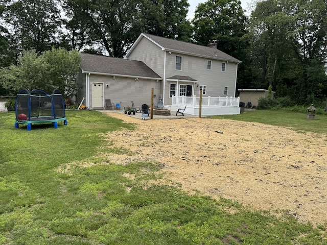 39 Warner St, Bristol, CT 06010 - rear view of house with a trampoline, a patio area, a yard, and a chimney