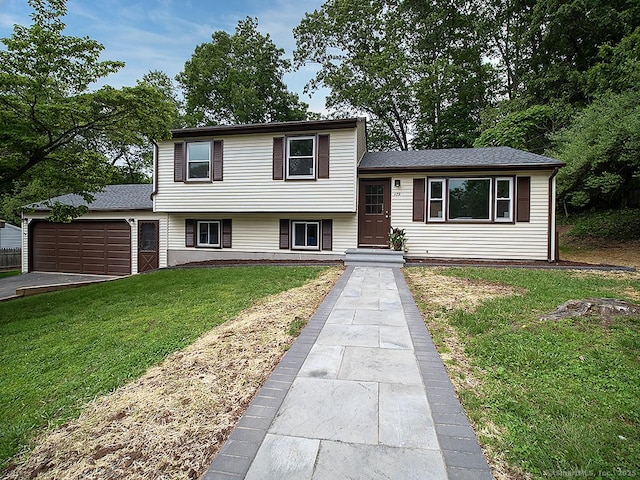179 Anns Farm Rd, Hamden, CT 06518 - tri-level home with a front lawn and a garage