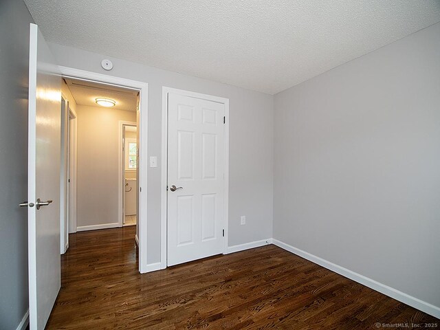 179 Anns Farm Rd, Hamden, CT 06518 - unfurnished bedroom featuring wood finished floors, baseboards, and a textured ceiling