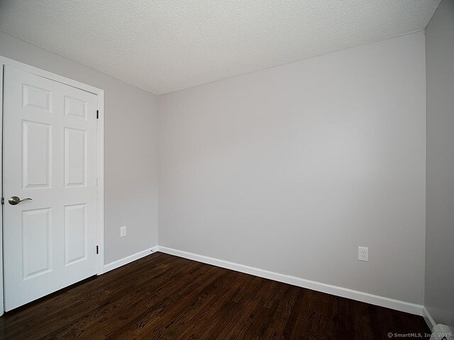 179 Anns Farm Rd, Hamden, CT 06518 - unfurnished room featuring dark wood-type flooring, baseboards, and a textured ceiling