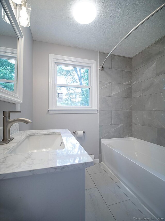 179 Anns Farm Rd, Hamden, CT 06518 - bathroom featuring marble finish flooring, a textured ceiling, vanity, and bathing tub / shower combination