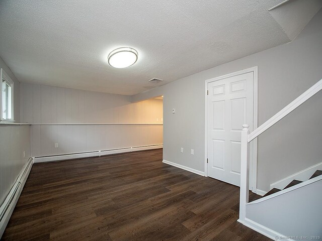 179 Anns Farm Rd, Hamden, CT 06518 - below grade area featuring wood finished floors, stairway, baseboard heating, a textured ceiling, and baseboards