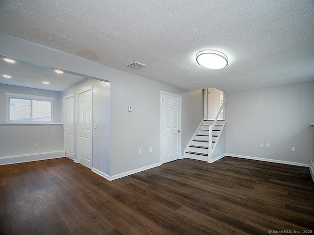 179 Anns Farm Rd, Hamden, CT 06518 - basement featuring wood finished floors, baseboards, a textured ceiling, and stairway
