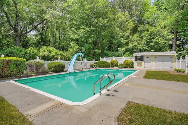 27 Kitcher Ct, Trumbull, CT 06611 - view of swimming pool with a water slide, a patio, an outbuilding, and a diving board