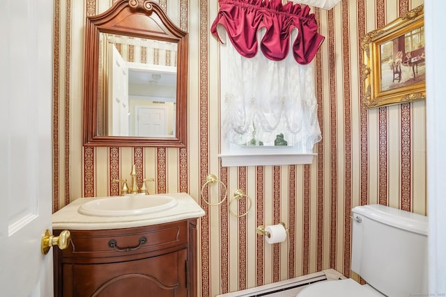 27 Kitcher Ct, Trumbull, CT 06611 - bathroom featuring vanity, toilet, a baseboard heating unit, and wallpapered walls