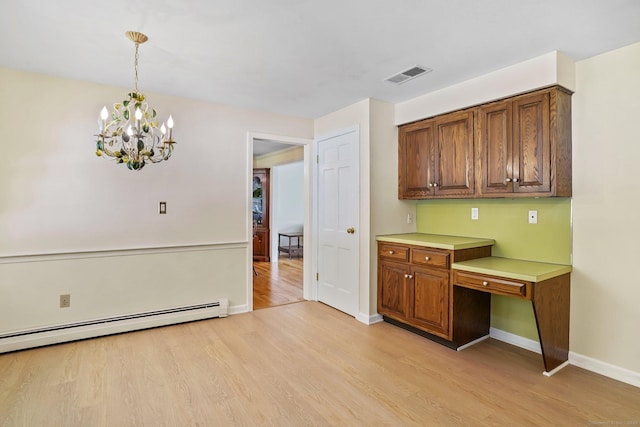 27 Kitcher Ct, Trumbull, CT 06611 - kitchen with light wood-style floors, brown cabinetry, a chandelier, baseboards, and light countertops