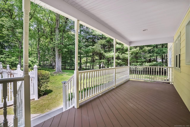 27 Kitcher Ct, Trumbull, CT 06611 - wooden porch with a lawn and view of wooded area