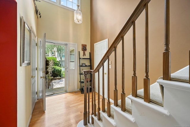156 Governor Trumbull Way Unit 156, Trumbull, CT 06611 - foyer entrance featuring stairway, light wood-type flooring, and a towering ceiling