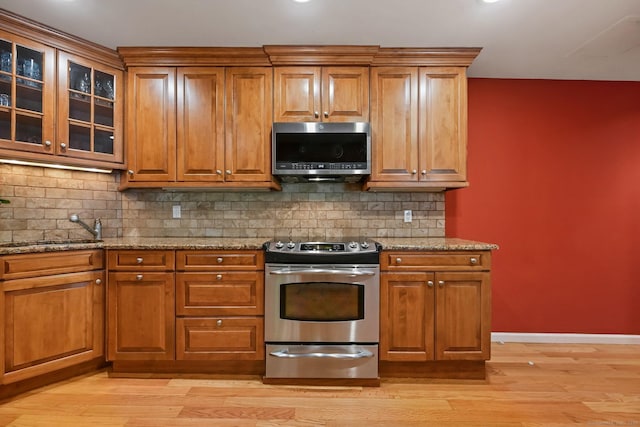 156 Governor Trumbull Way Unit 156, Trumbull, CT 06611 - kitchen with stainless steel appliances, light stone countertops, and brown cabinets
