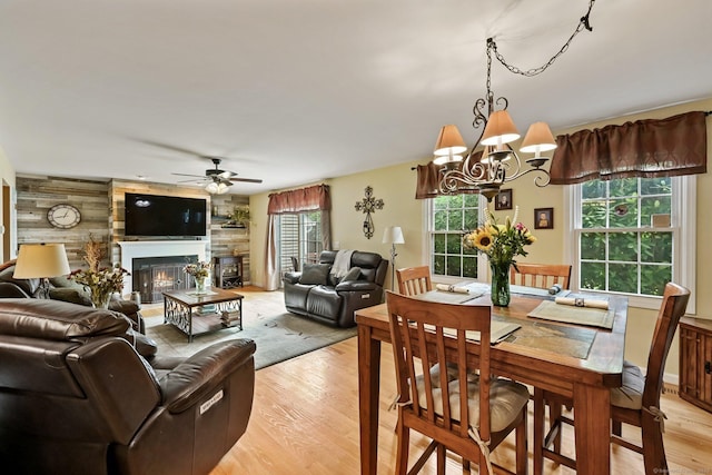 156 Governor Trumbull Way Unit 156, Trumbull, CT 06611 - dining room featuring light wood-style flooring, ceiling fan, a warm lit fireplace, and a chandelier