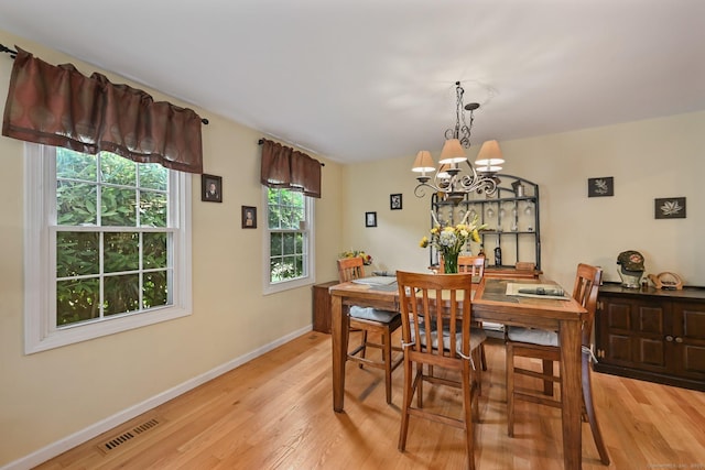 156 Governor Trumbull Way Unit 156, Trumbull, CT 06611 - dining area with light wood-style floors and a chandelier