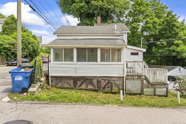 231 Broad St, Norwich, CT 06360 - bungalow-style house featuring a shingled roof, a sunroom, a chimney, and stairs