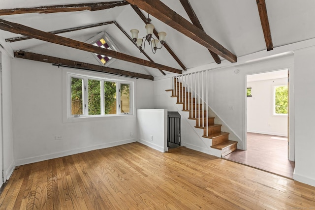 231 Broad St, Norwich, CT 06360 - unfurnished living room with stairs, light wood-style floors, a chandelier, and baseboards
