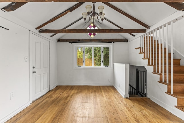 231 Broad St, Norwich, CT 06360 - unfurnished living room featuring light wood-type flooring, a chandelier, baseboards, and stairs