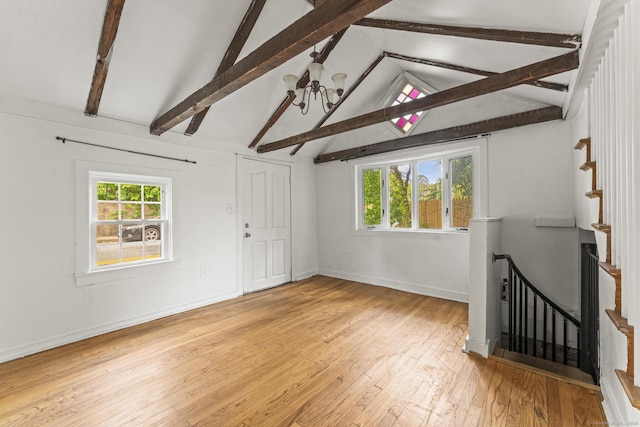 231 Broad St, Norwich, CT 06360 - unfurnished living room with healthy amount of natural light, hardwood / wood-style flooring, baseboards, and a chandelier