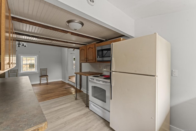 231 Broad St, Norwich, CT 06360 - kitchen with white appliances, light wood-style flooring, brown cabinets, and baseboards