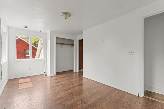 231 Broad St, Norwich, CT 06360 - unfurnished bedroom featuring wood finished floors, a closet, and baseboards