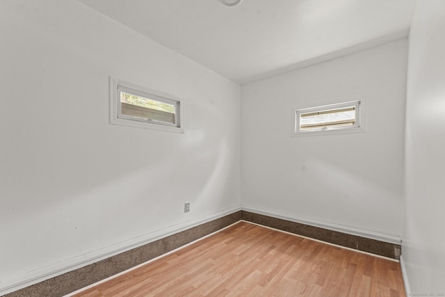 231 Broad St, Norwich, CT 06360 - empty room with wood finished floors and baseboards