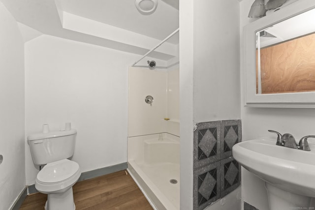 231 Broad St, Norwich, CT 06360 - bathroom featuring a shower, wood finished floors, toilet, and baseboards