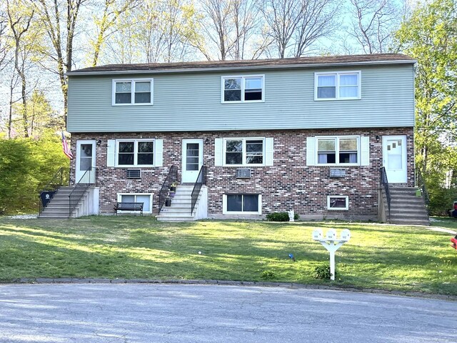 102 Caesar Dr, Bristol, CT 06010 - view of front of property with a front yard, brick siding, and stairway