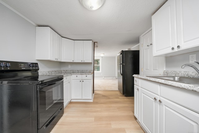 74 Mill St, Middletown, CT 06457 - kitchen with black appliances, a sink, light wood finished floors, white cabinetry, and a textured ceiling