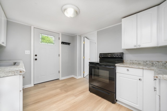 74 Mill St, Middletown, CT 06457 - kitchen with black / electric stove, light wood-type flooring, white cabinets, baseboards, and a sink