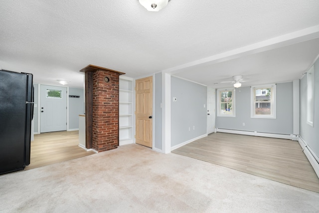 74 Mill St, Middletown, CT 06457 - unfurnished living room featuring a baseboard heating unit, ceiling fan, a textured ceiling, carpet flooring, and wood finished floors