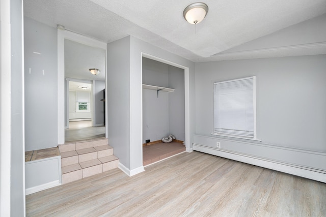 74 Mill St, Middletown, CT 06457 - unfurnished bedroom featuring wood finished floors, a baseboard heating unit, a closet, and baseboards