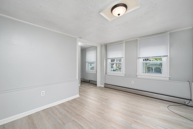 74 Mill St, Middletown, CT 06457 - unfurnished room featuring a textured ceiling, wood finished floors, baseboard heating, and baseboards