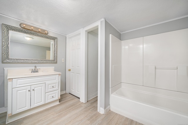 74 Mill St, Middletown, CT 06457 - bathroom featuring wood finished floors, vanity, a textured ceiling, baseboards, and shower / tub combination