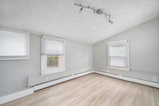 74 Mill St, Middletown, CT 06457 - unfurnished room with a textured ceiling, vaulted ceiling, wood finished floors, and track lighting