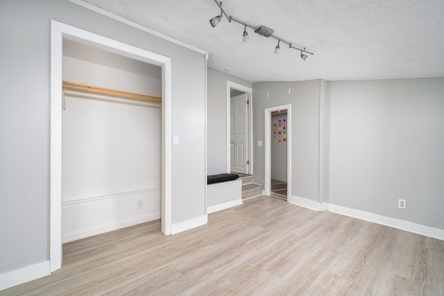 74 Mill St, Middletown, CT 06457 - unfurnished bedroom with wood finished floors, a textured ceiling, and baseboards