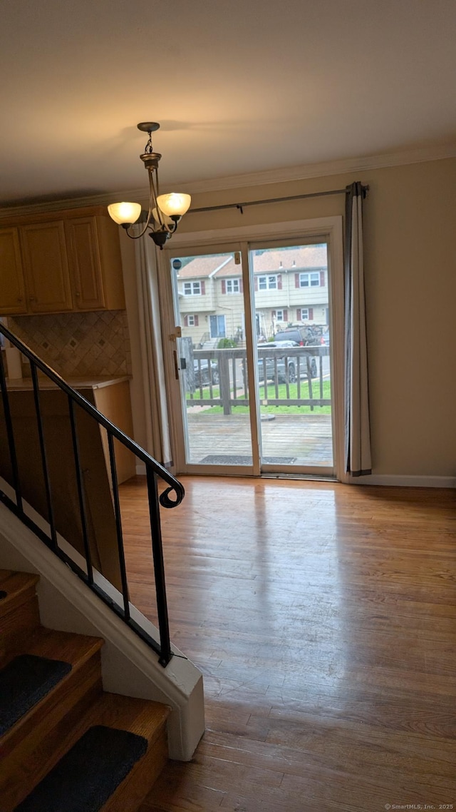 70 Lantern Park Dr Unit 1, Naugatuck, CT 06770 - stairs featuring wood finished floors, ornamental molding, a chandelier, and baseboards