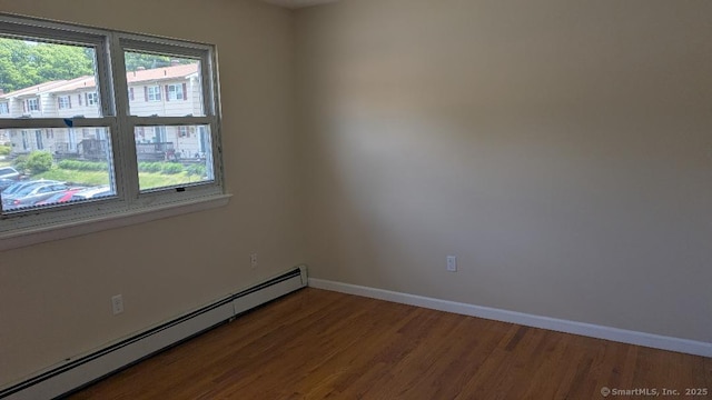 70 Lantern Park Dr Unit 1, Naugatuck, CT 06770 - empty room featuring baseboard heating, wood finished floors, and baseboards