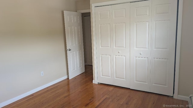 70 Lantern Park Dr Unit 1, Naugatuck, CT 06770 - unfurnished bedroom with a closet, wood finished floors, and baseboards