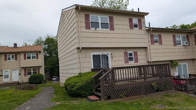 70 Lantern Park Dr Unit 1, Naugatuck, CT 06770 - back of property featuring a wooden deck, cooling unit, and a lawn