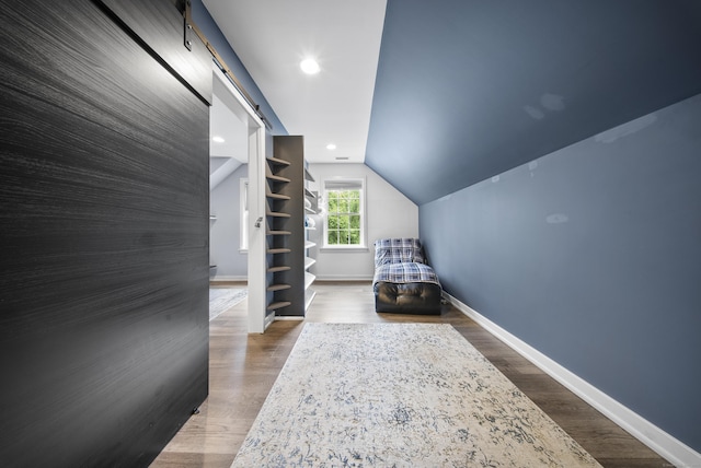 108 Hamburg Rd, Lyme, CT 06371 - bedroom featuring a barn door, baseboards, lofted ceiling, and wood finished floors