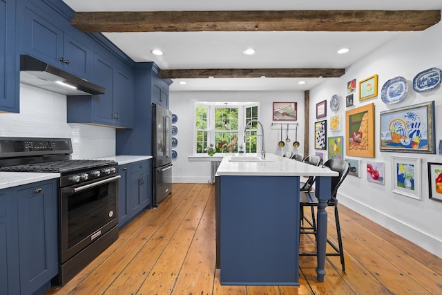 354 Rte 7 N, Canaan, CT 06031 - kitchen featuring gas range oven, a sink, under cabinet range hood, blue cabinetry, and beam ceiling