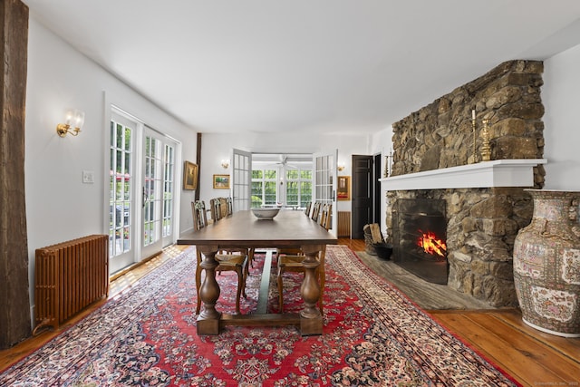354 Rte 7 N, Canaan, CT 06031 - dining area with hardwood / wood-style floors, radiator heating unit, ceiling fan, and a fireplace