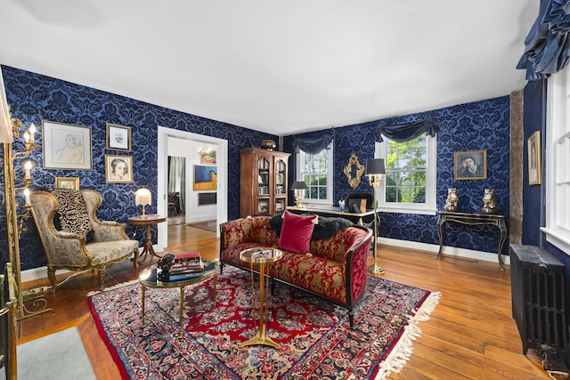 354 Rte 7 N, Canaan, CT 06031 - living room featuring wallpapered walls, radiator, wood finished floors, and baseboards