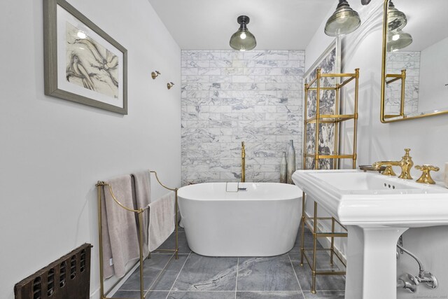 354 Rte 7 N, Canaan, CT 06031 - full bathroom with a freestanding bath, radiator heating unit, marble look tile flooring, and tile walls